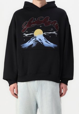 Black hoodie featuring a graphic design of mountains, a yellow sun, and stars. Accented with a red, sparkling text above the design.