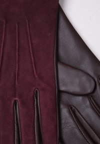 Leather and suede gloves; one side burgundy suede with stitching details, the other side dark brown textured leather with smooth accents.