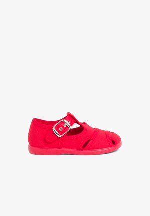 Red canvas shoe with an open toe design, adjustable strap with silver buckle, and textured rubber sole. Side cutouts enhance breathability.