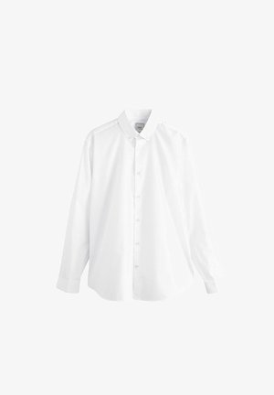 Valge pika varrukaga nööpidega särk klassikalise kraega, valmistatud siledast kangast. Omab esist plagu ja ümarat allaäärtega, millel on nööpidega mansetid.