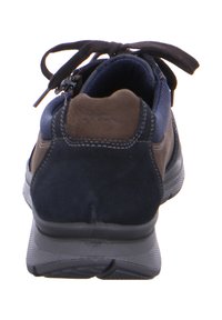 Men’s sneaker with navy blue and brown suede panels, black laces, and a textured gray sole, viewed from the heel.