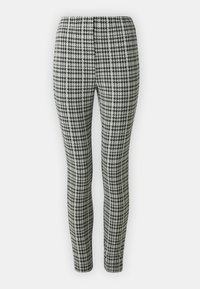Leggingi s uzorkom houndstooth u crnoj i bijeloj boji, s elastičnim pojasom, uskog kroja i glatke teksture tkanine.