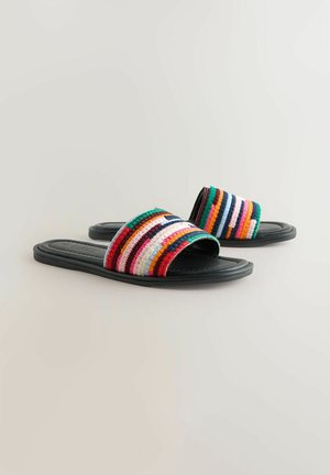 Colorful woven slide sandals with a multi-striped upper in red, green, blue, white, and pink, paired with a black flat sole.