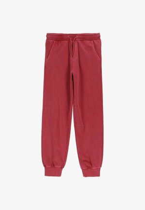 Czerwone spodnie dresowe z elastycznym pasem i ściągaczami, przednimi kieszeniami oraz sznurkiem do zawiązywania, ułożone na płasko na białym tle.