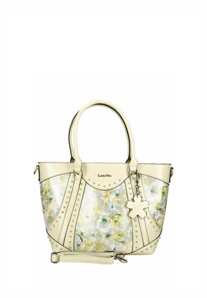 Sac à main en cuir crème avec panneaux à motif floral, clous décoratifs en métal, deux poignées, bandoulière amovible et porte-clés en forme de fleur.