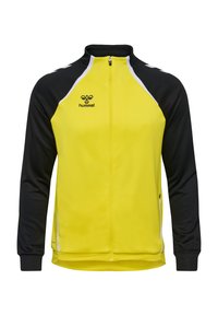 Chaqueta amarilla y negra con un cuello alto, cierre de cremallera y acentos blancos en contraste. Fabricada con un tejido ligero y suave, presenta un logo en el pecho.