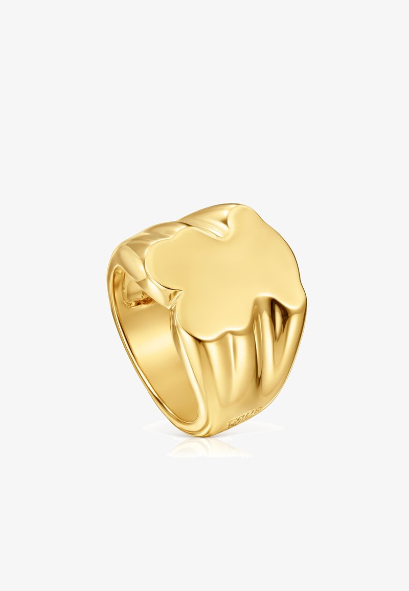 Gold signet ring with a smooth, rounded four-leaf clover design on top, polished finish, and a wide band.