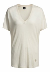 Beżowy t-shirt z dekoltem w serek, wykonany z miękkiego materiału, z krótkimi rękawami i subtelnym logo w dolnym lewym rogu.