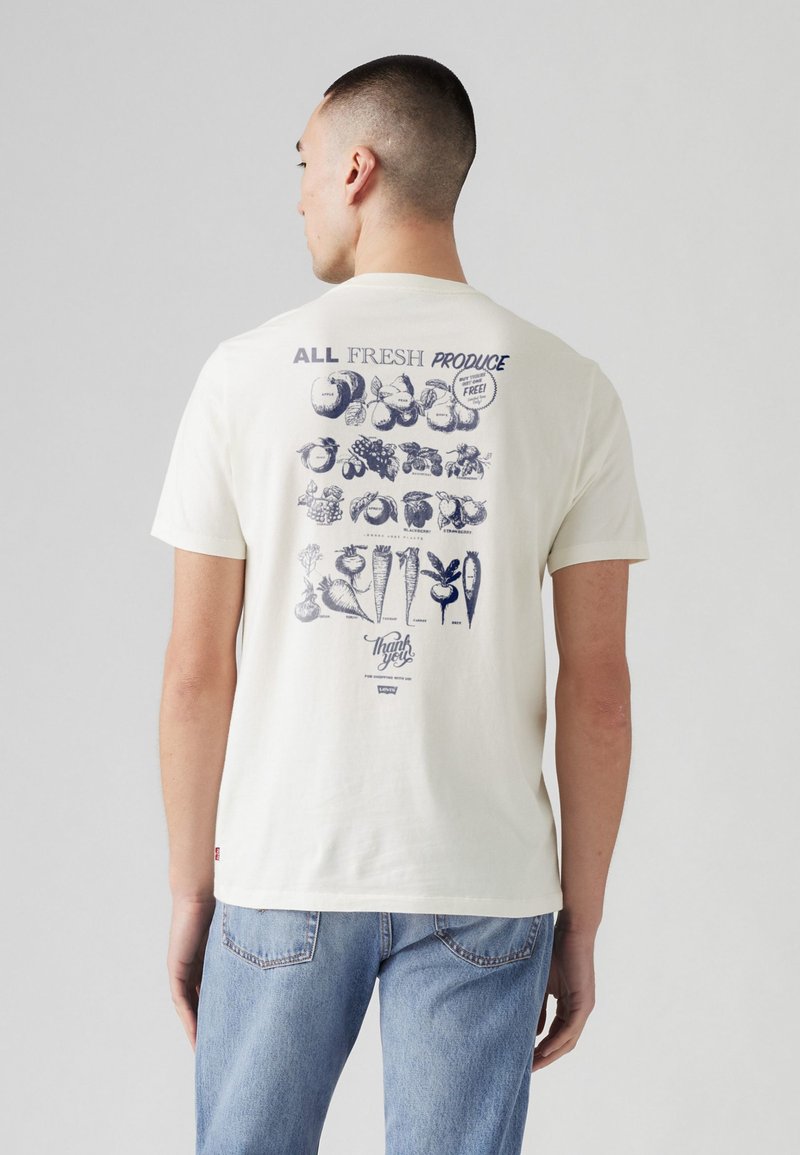White cotton t-shirt with a graphic of various fruits and vegetables in navy blue on the back, text "ALL FRESH PRODUCE" above the design.