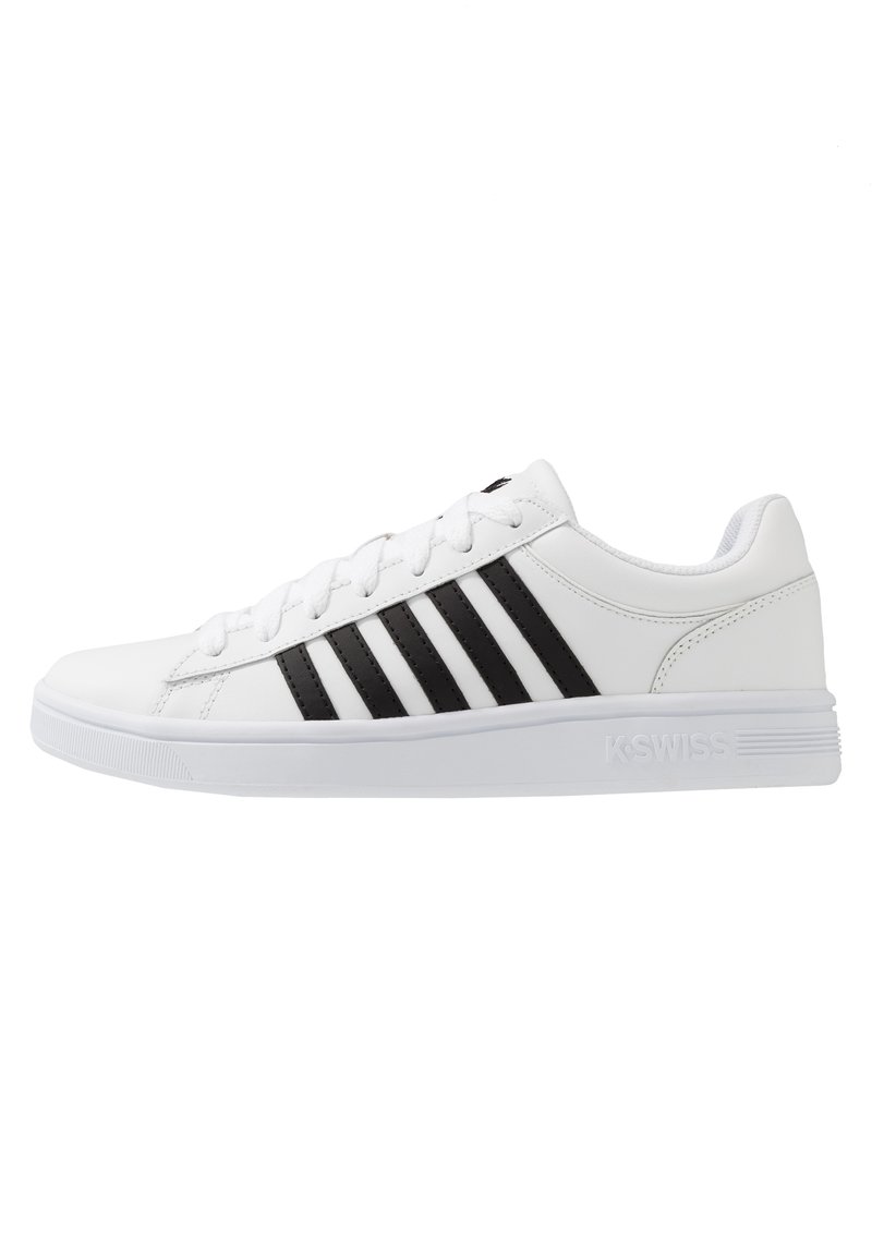 White athletic shoe with black stripes, made of synthetic material. Features flat laces, a padded collar, and rubber sole with textured traction.