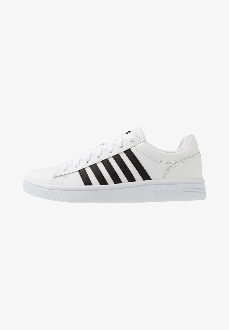 White athletic shoe with black stripes, made of synthetic material. Features flat laces, a padded collar, and rubber sole with textured traction.