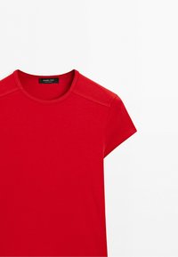 Red short-sleeve t-shirt with round neck and visible stitching on shoulders, labeled Massimo Dutti on a black tag at the collar.