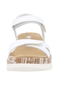 White faux leather sandal with adjustable strap, cork sole featuring a white geometric pattern, and a soft beige footbed.