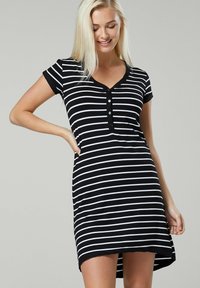 Black and white striped dress with short sleeves, v-neck, button closure, and a rounded hemline that is longer in the back. Soft fabric texture.