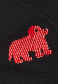 Zwarte stof met een rood, gestreept geborduurd honden silhouet met opvallende oren en ogen, gepositioneerd aan de onderkant van de afbeelding.
