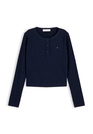 Marineblå ribbestrikket langermet skjorte med rund hals, tre knapper foran og lite Tommy Hilfiger-logo på brystet.