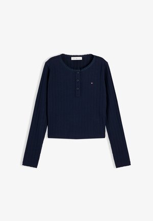 Chemise à manches longues côtelée bleu marine avec encolure ronde, trois boutons à l'avant et petit logo Tommy Hilfiger sur la poitrine.
