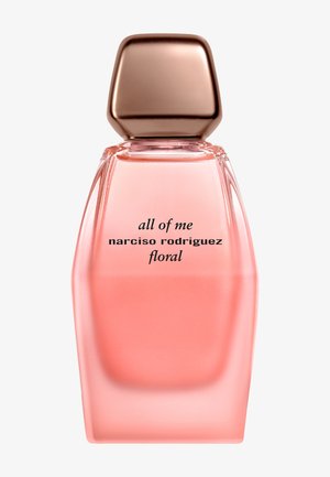 Blomstrande parfymflaska med en rosa gradient, rektangulär form och ett roséguldigt fyrkantigt lock. Texten på flaskan säger "all of me narciso rodriguez floral."
