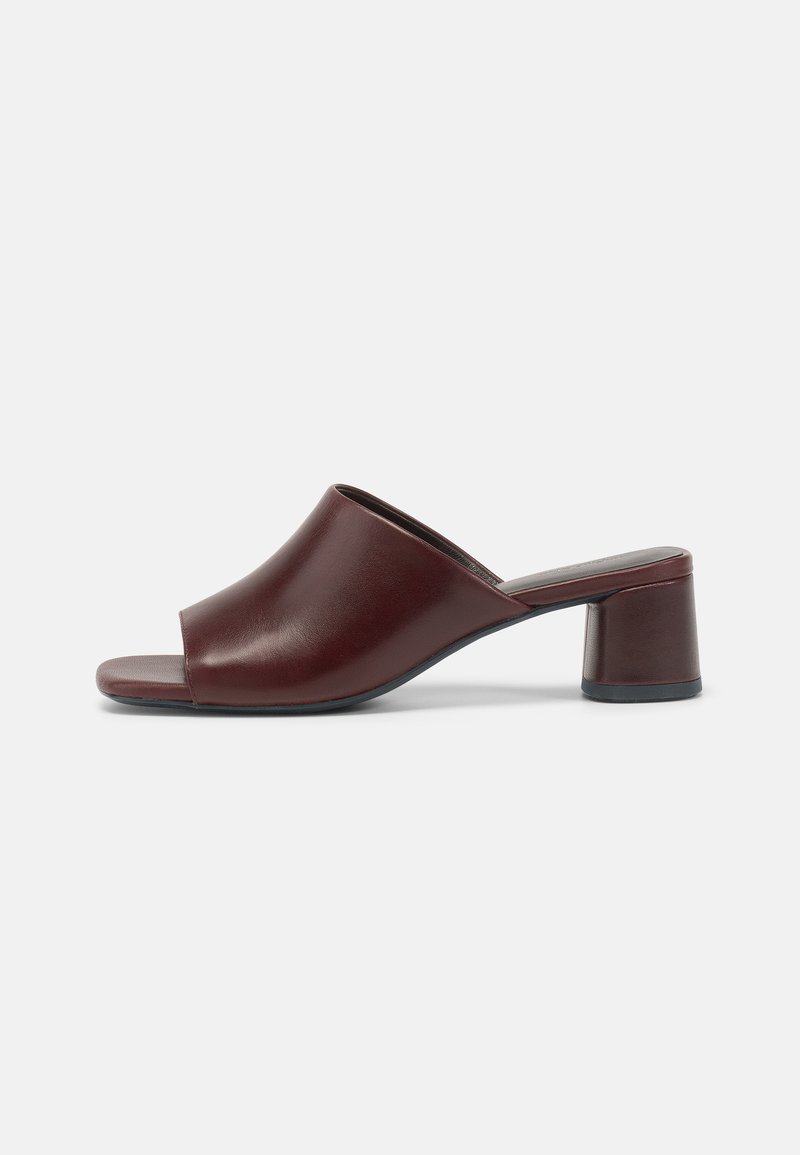 Dark burgundy open-toe slide sandals made of smooth leather with a rounded design and a chunky heel for stability. Side view shown.