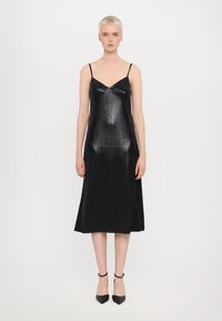 Schwarzes Satin-Hängerchenkleid mit dünnen Trägern, einem V-Ausschnitt und einer strukturierten Oberfläche. Knöchellang mit lockerer Passform und seitlichen Schlitzen.