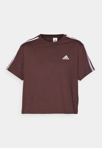 Brun bomull t-shirt med rund hals, korta ärmar och tre vita ränder på varje axel. Har Adidas-logotypen på bröstet.