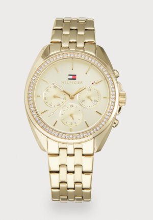Orologio da polso Tommy Hilfiger in tonalità oro con quadrante in cristallo, tre sottodial per giorno, data e ora in formato 24 ore, e bracciale metallico a maglie.