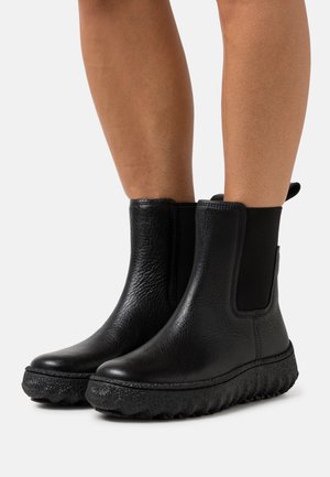 Stivali Chelsea neri con tomaia in pelle texturizzata, pannelli elasticizzati sui lati e suola in gomma spessa e patterned.