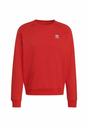 Červená mikina s kulatým výstřihem a žebrovanými manžetami. Na hrudi se nachází malé bílé logo Adidas. Vyrobena z měkké bavlny.