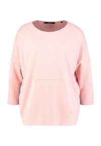 T-shirt rose à manches longues avec un col rond, présentant un motif texturé et une coupe décontractée. Devant lisse avec texture côtelée sur les manches.