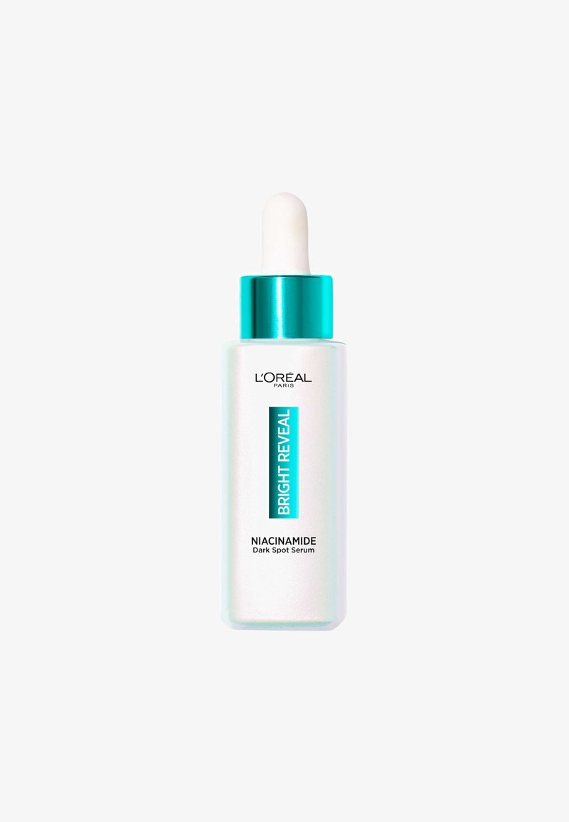 Sérum anti-taches à la niacinamide de L'Oréal Paris dans un flacon en verre dépoli avec un capuchon turquoise, doté d'un compte-gouttes blanc et d'un texte bleu sur l'étiquette.