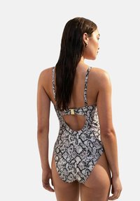 One-piece swimsuit with a snake print pattern, adjustable spaghetti straps, and a keyhole back detail. Color scheme features beige, black, and grey.