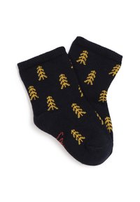 Chaussettes en coton bleu marine avec des motifs d'arbres jaunes, des bords côtes et un accent rouge sur la semelle. Texture douce, design de longueur cheville.