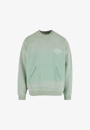 Mentazöld pulóver, pamutból készült, kerek nyakkivágással, hosszú ujjakkal, elülső zsebbel és logóval a mellkasán. Puha tapintású.