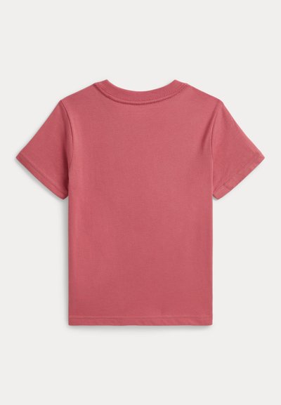 T-shirt uni à manches courtes de couleur rose poudré, vu de dos, avec un col rond et des détails de couture simples.