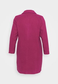 Magenta frakke med klassisk krave, lange ærmer og lige snit. Lavet af tekstureret stof uden synlige lukninger eller mønstre.