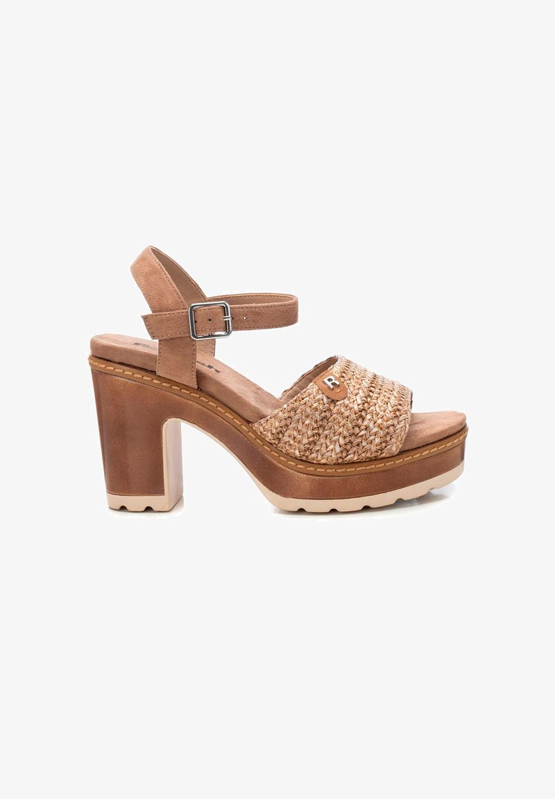 Sandal de tacón bloque marrón con tira de paja trenzada, tira de ante en el tobillo y hebilla de metal. Plantilla acolchada con una suela de plataforma resistente.