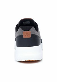 Gray and black sneaker with a textured upper, a brown accent label at the heel, and a white midsole. Rounded toe and cushioned sole.