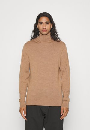 Maglione a collo alto marrone chiaro realizzato in tessuto morbido, con un design aderente, maniche lunghe e un leggero accento del logo sul petto.