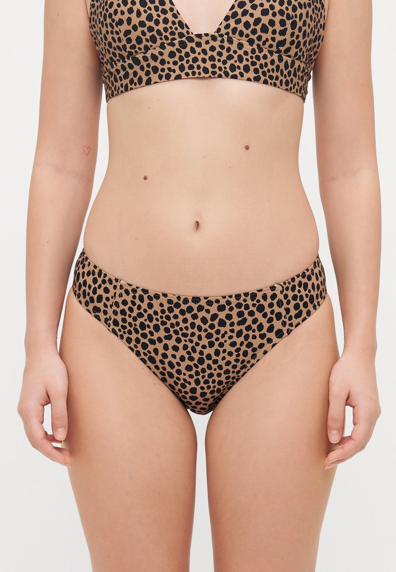 Leopard print bikini set in tan and black tones. The top features a V-neck design, while the bottoms have a low-rise cut with seamless edges.