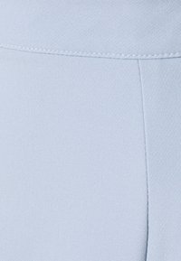 Lichtblauwe stof met een gladde textuur en subtiele glans. Voorzien van gestikte naden en een eenvoudig ontwerp, geschikt voor verschillende omgevingen.