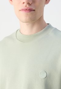 HUGO NINNYO - Felpa - light pastel green