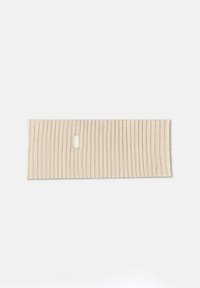 Beige ribbat tyg huvudband med en liten vit logotag. Mjuk textur, rektangulär form och jämna vertikala linjer över hela ytan.