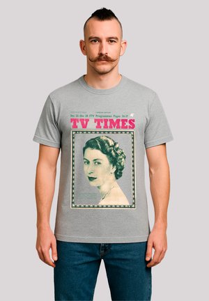 Gray cotton t-shirt featuring a retro image of a woman with dark hair and a necklace, framed by colorful print text "TV TIMES."