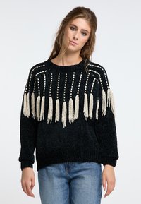 Schwarzer Strickpullover mit cremefarbenen Fransen am Saum und einem strukturierten Muster. Verfügt über einen runden Halsausschnitt und gerippte Bündchen. Lässige Passform.