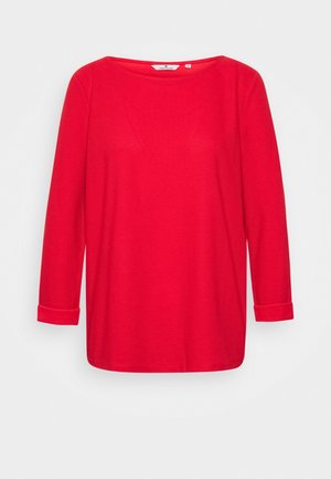 Red long-sleeve top with a round neckline and rolled cuffs. Textured fabric with subtle seams. Simple design, suitable for casual wear.
