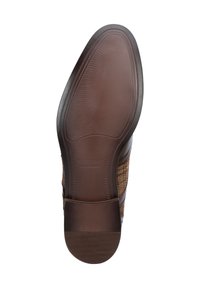 Semelle en cuir avec une texture en caoutchouc brun offrant une bonne adhérence et un talon lisse, marron foncé. Présente un marquage en relief et une forme ovale.