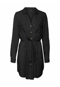 Vestido negro de camisa hecho de una tela ligera, con cuello, botones dorados en la parte delantera, dos bolsillos en el pecho y un detalle de cintura anudada. Manga larga.
