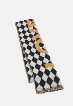 Folded black and white checkered scarf with large mustard yellow letters and fringed ends on a white background.