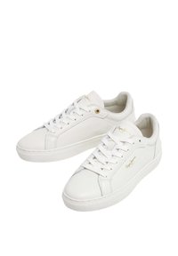 White sneakers with a smooth leather finish, rounded toe, flat rubber sole, and side stitching; features gold logo accents and lace-up design.