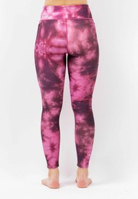 High-waisted leggings in a tie-dye pattern of pink and dark purple. Made from stretchy fabric, featuring a seamless design and fitted shape.